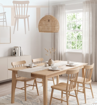 Scandinavian dining room with natural wood table and woven lamp.