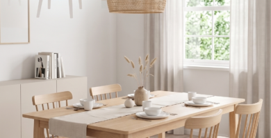 Scandinavian dining room with natural wood table and woven lamp.